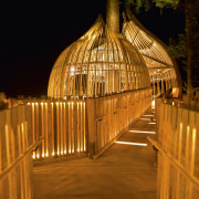 Image of the Yellow Treehouse restaurant which has architecture, landscape lighting, light, lighting, night, reflection, wood, brown, black