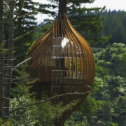 Image of the Yellow Treehouse restaurant which has biome, hut, log cabin, outdoor structure, tree, wood, brown, green