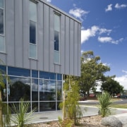 Exterior view of school which features cladding manufactured architecture, building, condominium, corporate headquarters, facade, home, house, property, real estate, sky, window, gray