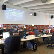 View of a working station with IT equipment. classroom, conference hall, institution, office, gray