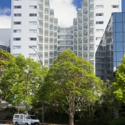 Exterior view of the Federal Apartments which where apartment, architecture, arecales, building, city, condominium, daytime, downtown, metropolis, metropolitan area, mixed use, neighbourhood, palm tree, plant, real estate, residential area, road, sky, skyscraper, suburb, tower block, tree, urban area, urban design, white