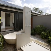 View of an outdoor freestanding bathtub and shower architecture, home, house, property, real estate, white