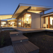 Exterior view of a family home designed and architecture, backyard, estate, facade, home, house, lighting, property, real estate, residential area, roof, villa, window, black