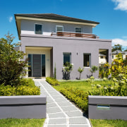 Exterior view of the front of a family building, cottage, elevation, estate, facade, grass, home, house, mansion, neighbourhood, property, real estate, residential area, sky, suburb, villa, teal