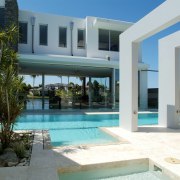 Exterior view of tropical resort-style house which was apartment, condominium, estate, home, hotel, house, property, real estate, resort, swimming pool, villa, white, teal