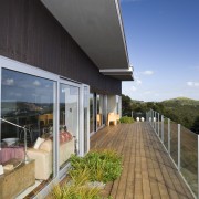 View of the exterior of this holiday home apartment, architecture, daylighting, facade, home, house, real estate, residential area, roof, sky, window, gray