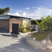 View of the exterior of this holiday home cottage, home, house, property, real estate, shed, gray