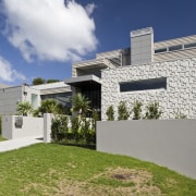 Exterior view of the front entrance with landscaping, architecture, building, cottage, elevation, estate, facade, home, house, property, real estate, residential area, siding, sky, villa, white