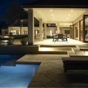 Exterior view of a home which was designed apartment, architecture, estate, home, house, interior design, lighting, property, real estate, swimming pool, villa, window, brown