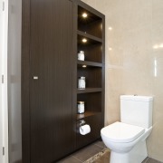 View of a bathroom desiged by a Yellow bathroom, bathroom accessory, bathroom cabinet, cabinetry, interior design, plumbing fixture, room, gray