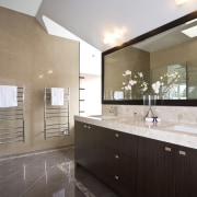 View of a bathroom designed by a Yellow bathroom, cabinetry, countertop, estate, floor, home, interior design, kitchen, property, real estate, room, sink, white