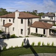 Exterior view of a Mediterranean-style house built by apartment, building, elevation, estate, facade, hacienda, home, house, mansion, neighbourhood, property, real estate, residential area, roof, suburb, villa, brown