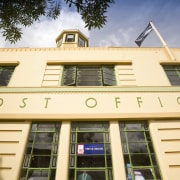 Exterior view of a restored post office building apartment, architecture, building, commercial building, condominium, daytime, elevation, estate, facade, home, hotel, house, property, real estate, residential area, window, orange