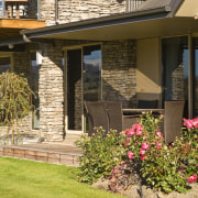 Image of this new home in central Otago facade, home, house, landscaping, outdoor structure, porch, property, real estate, residential area, siding, window, yard, brown, orange