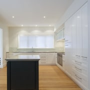 Kitchen featuring, timber flooring, kitchen island, sinks and architecture, cabinetry, ceiling, countertop, daylighting, floor, flooring, hardwood, home, house, interior design, kitchen, laminate flooring, property, real estate, room, wood flooring, gray