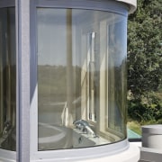 View of a curved bathroom window which was glass, window, gray