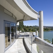View of a curved glass balustrade from Glasshape. architecture, building, condominium, estate, house, real estate, sky, structure, white, gray