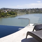 View of a curved glass balustrade from Glasshape. bay, coastal and oceanic landforms, lake, real estate, reservoir, river, sea, sky, swimming pool, water, water resources, waterway, gray, white