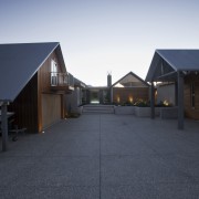 Exterior view of home with a gabled roof, architecture, asphalt, building, cottage, estate, facade, home, house, lighting, property, real estate, residential area, roof, shed, siding, sky, suburb, black, gray