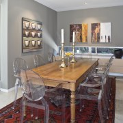 View of the dining area which features an ceiling, chair, dining room, floor, furniture, home, interior design, kitchen, living room, room, table, gray