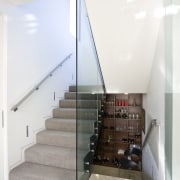 view of stairway with carpeted steps, glass wall architecture, glass, handrail, house, interior design, stairs, white