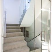 view of stairway with carpeted steps, glass wall architecture, ceiling, daylighting, glass, handrail, home, house, interior design, product design, stairs, white