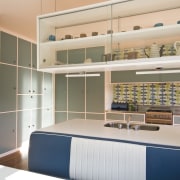 View of a kitchen which features blue cabinetry cabinetry, furniture, interior design, kitchen, product, room, shelving, gray
