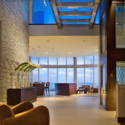 View of open-plan living area with sofas and architecture, ceiling, daylighting, interior design, lobby, brown