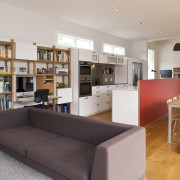 View of open-plan kitchen area which features an bookcase, furniture, institution, interior design, library, living room, real estate, room, shelving, gray