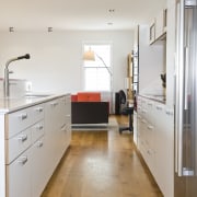 View of open-plan kitchen area which features an cabinetry, countertop, floor, flooring, hardwood, interior design, kitchen, laminate flooring, loft, real estate, room, tile, wood, wood flooring, gray