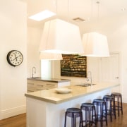 View of a kitchen featuring long island with ceiling, countertop, cuisine classique, floor, flooring, home, interior design, kitchen, real estate, room, white