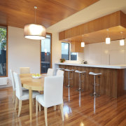 View of open-plan kitchen and dining area featuring ceiling, countertop, dining room, floor, flooring, hardwood, home, house, interior design, kitchen, laminate flooring, real estate, room, table, wood, wood flooring, brown, orange