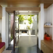 View of doorway leading to small enclosed courtyard. architecture, ceiling, home, house, interior design, property, real estate, brown, gray
