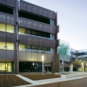 Exterior view of a building which features energy-efficient apartment, architecture, building, commercial building, condominium, corporate headquarters, facade, headquarters, metropolitan area, mixed use, real estate, residential area, white