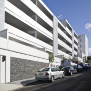 Exterior view of the Ivory apartments which features apartment, architecture, building, commercial building, condominium, corporate headquarters, facade, headquarters, house, metropolitan area, mixed use, motor vehicle, parking, parking lot, property, residential area, sky, black, white