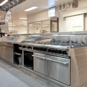 View of a heavy-suty cooking line supplied by countertop, kitchen, kitchen appliance, gray