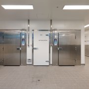 View of the 100m long production kitchen of door, floor, glass, gray