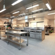 View of the 100m long production kitchen of cafeteria, gray