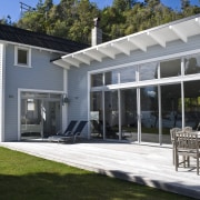 Image of the exterior which features redwood weatherboard backyard, cottage, estate, facade, home, house, porch, property, real estate, siding, window, white