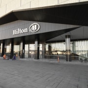 Exterior view of the Hilton Melbouren South Wharf building, facade, structure, gray, black