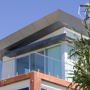 Exterior view of a home which features Alucobond architecture, building, commercial building, daylighting, facade, home, house, property, real estate, residential area, roof, window, teal