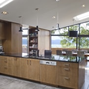 View of open-plan kitchen and dining area with cabinetry, countertop, cuisine classique, interior design, kitchen, real estate, gray, brown