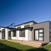 Exterior view of a David Reid Homes show architecture, building, cottage, elevation, estate, facade, home, house, property, real estate, residential area, siding, blue