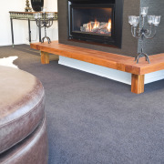 View of the lounge which was designed by coffee table, fireplace, floor, flooring, furniture, hardwood, hearth, laminate flooring, living room, table, wood, wood burning stove, wood flooring, gray