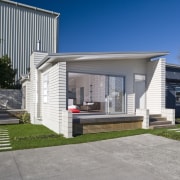 Exterior view of a Harmony Homes show home architecture, building, elevation, facade, home, house, luxury vehicle, property, real estate, residential area, siding, gray