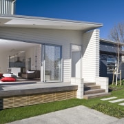 Exterior view of a Harmony Homes show home cottage, elevation, facade, home, house, luxury vehicle, property, real estate, residential area, siding, window, gray