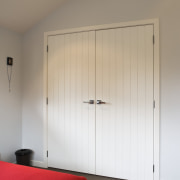 View of a bedroom at this ICR designed ceiling, door, floor, house, interior design, lighting, room, wall, wardrobe, wood, gray