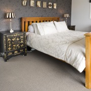 View of a bedroom area which features pure bed, bed frame, bed sheet, bedroom, duvet cover, floor, flooring, furniture, hardwood, home, interior design, laminate flooring, mattress, room, wall, wood, wood flooring, gray