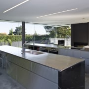 View of open-plan kitchen featuring polished concrete flooring, architecture, countertop, house, interior design, kitchen, real estate, gray, black