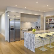 View of the kitchen at the Harbourcity developed cabinetry, countertop, floor, flooring, hardwood, interior design, kitchen, laminate flooring, real estate, room, wood flooring, gray